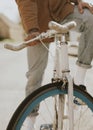 Tattooed hand holding onto bikeÃ¢â¬â¢s handlebar closeup